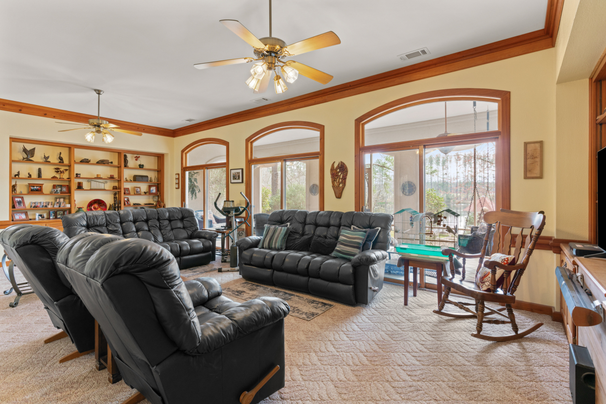 Open-concept living area with custom built-ins, granite countertops, and large windows with lake views