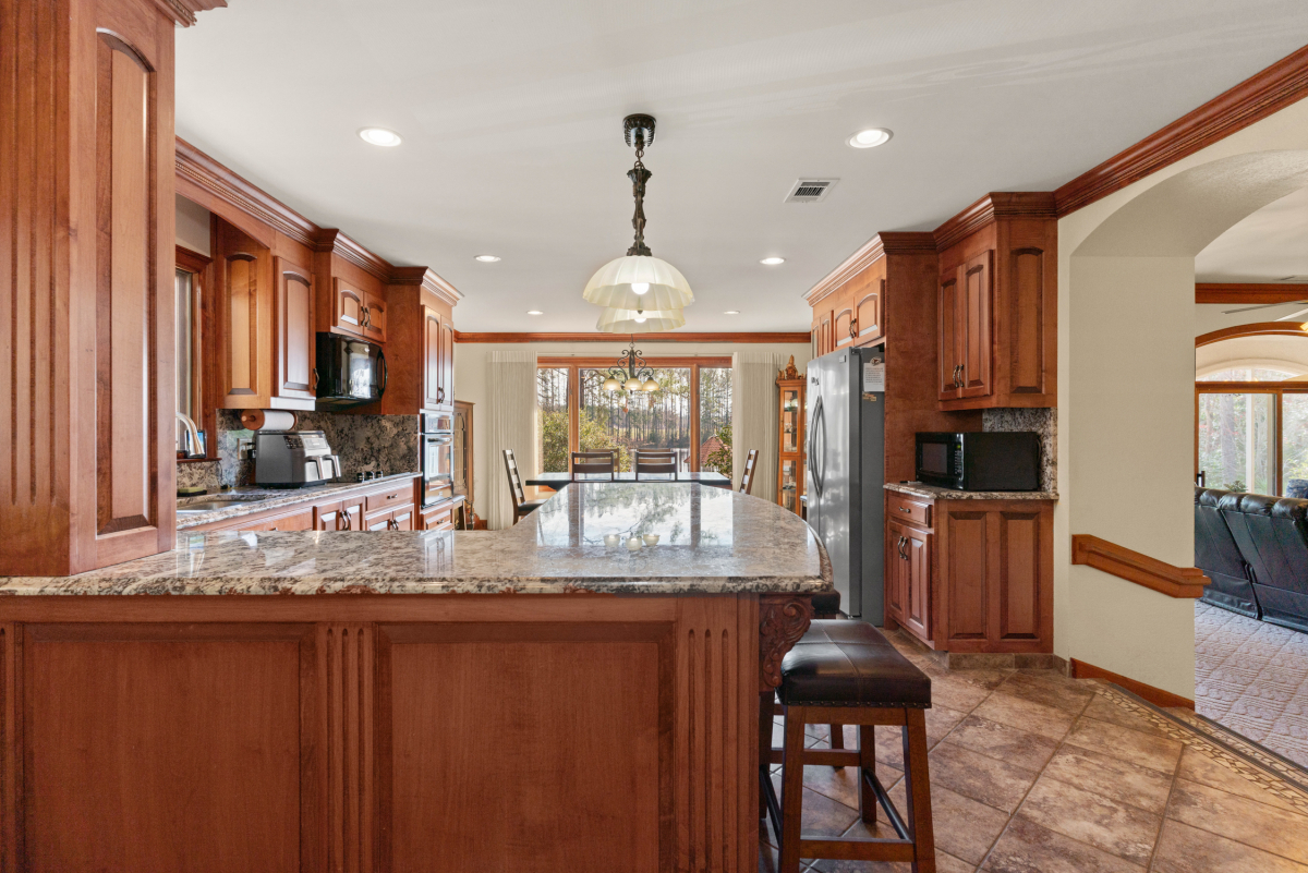 Modern kitchen with granite countertops, high-end appliances, and ample storage
