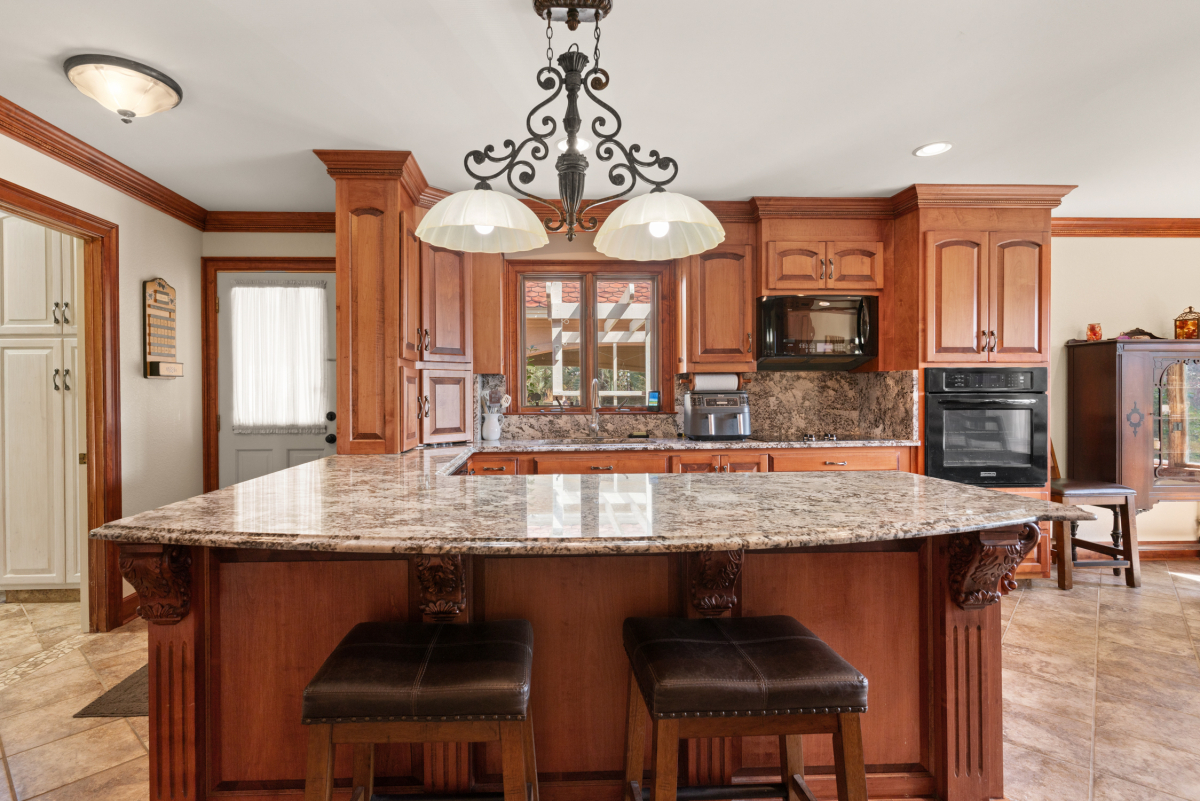 Modern kitchen with granite countertops, high-end appliances, and ample storage