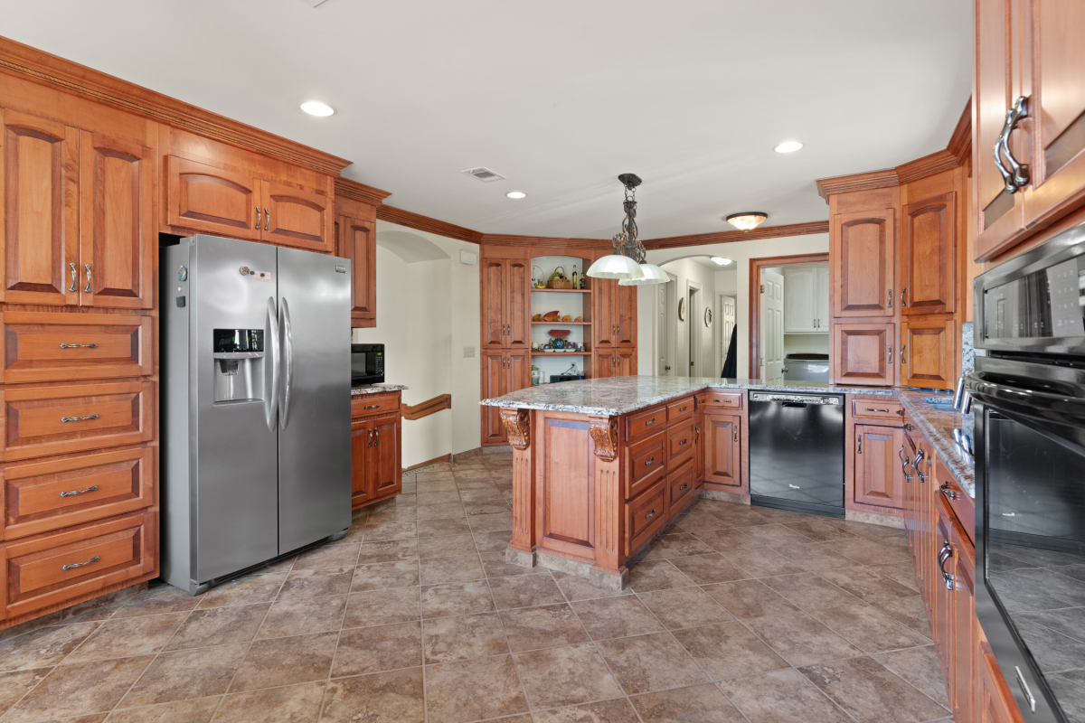 Modern kitchen with granite countertops, high-end appliances, and ample storage