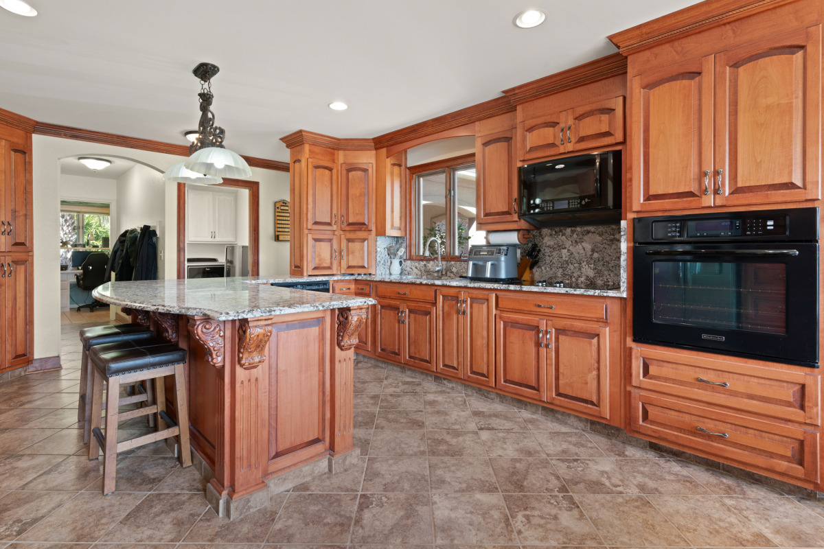 Modern kitchen with granite countertops, high-end appliances, and ample storage