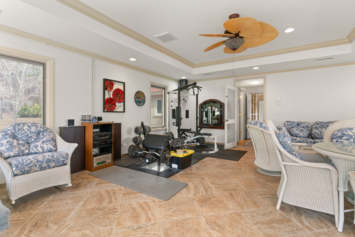 Indoor swim spa with lounge area and panoramic views of the stocked lake