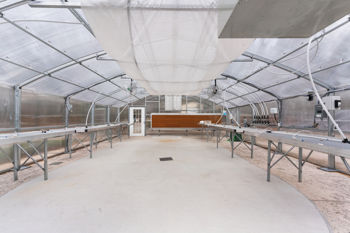 Solar-powered Atlas commercial greenhouse with an off-grid 12,000-watt lithium battery system
