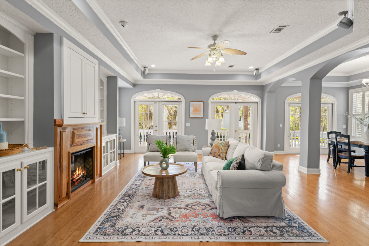Open living room with fireplace and custom built-ins in home for sale in Hampton Plantation