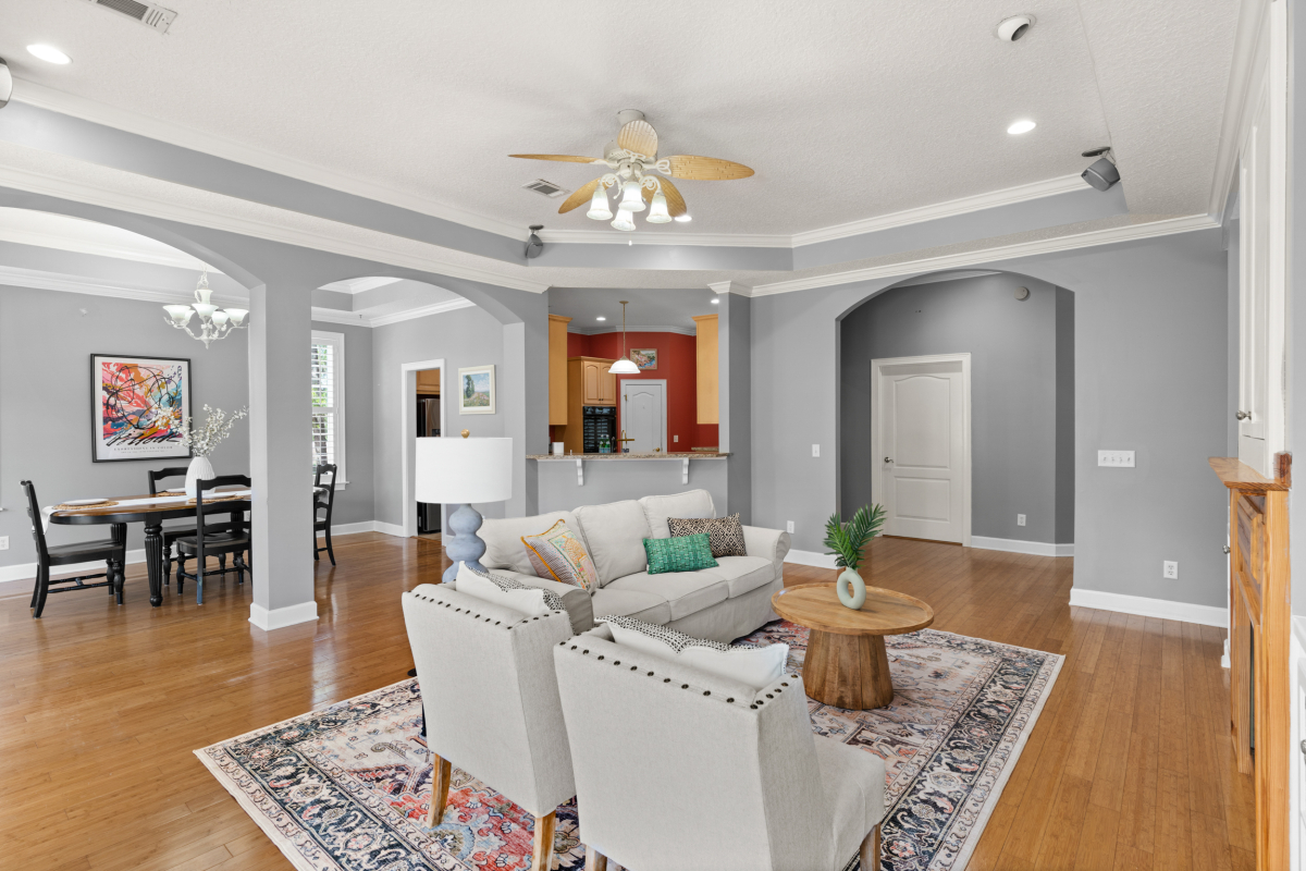 Open living room with fireplace and custom built-ins in home for sale in Hampton Plantation