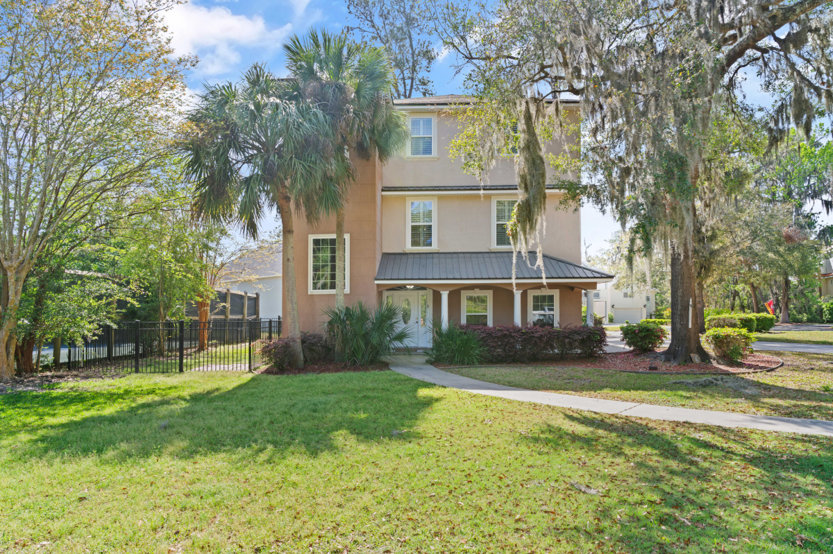 Three-story home for sale in Hampton Plantation St Simons Island GA with fenced yard and mature landscaping