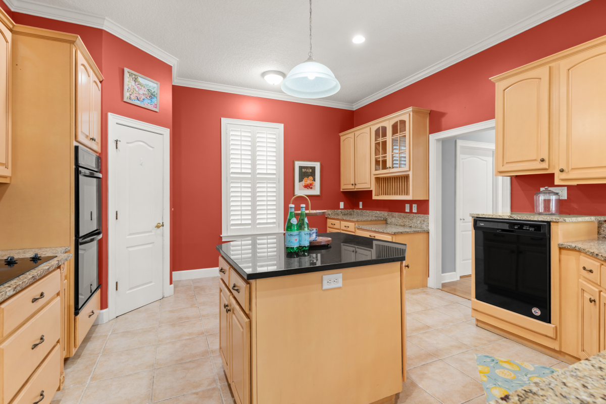 Bright kitchen with island, pantry, and built-in desk in St Simons Island GA home for sale