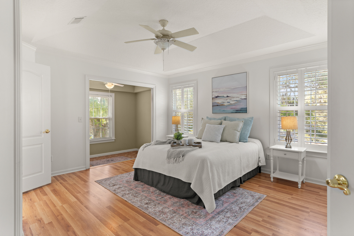 Spacious primary suite with sitting area and walk-in closet in St Simons Island home