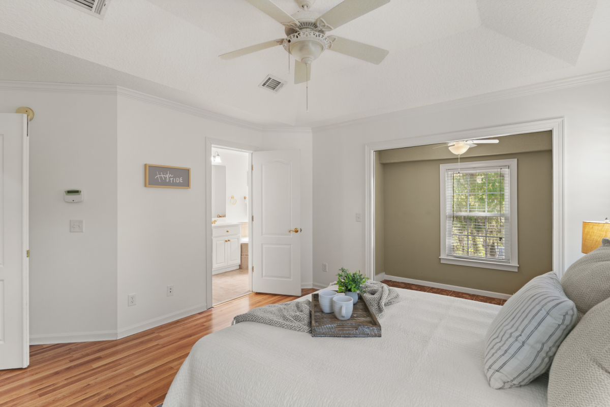 Spacious primary suite with sitting area and walk-in closet in St Simons Island home
