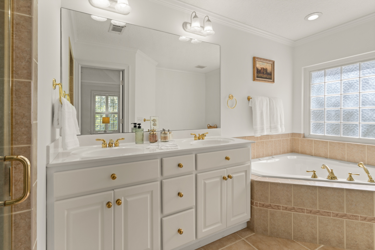 Primary bathroom with soaking tub and walk-in shower in Hampton Plantation home