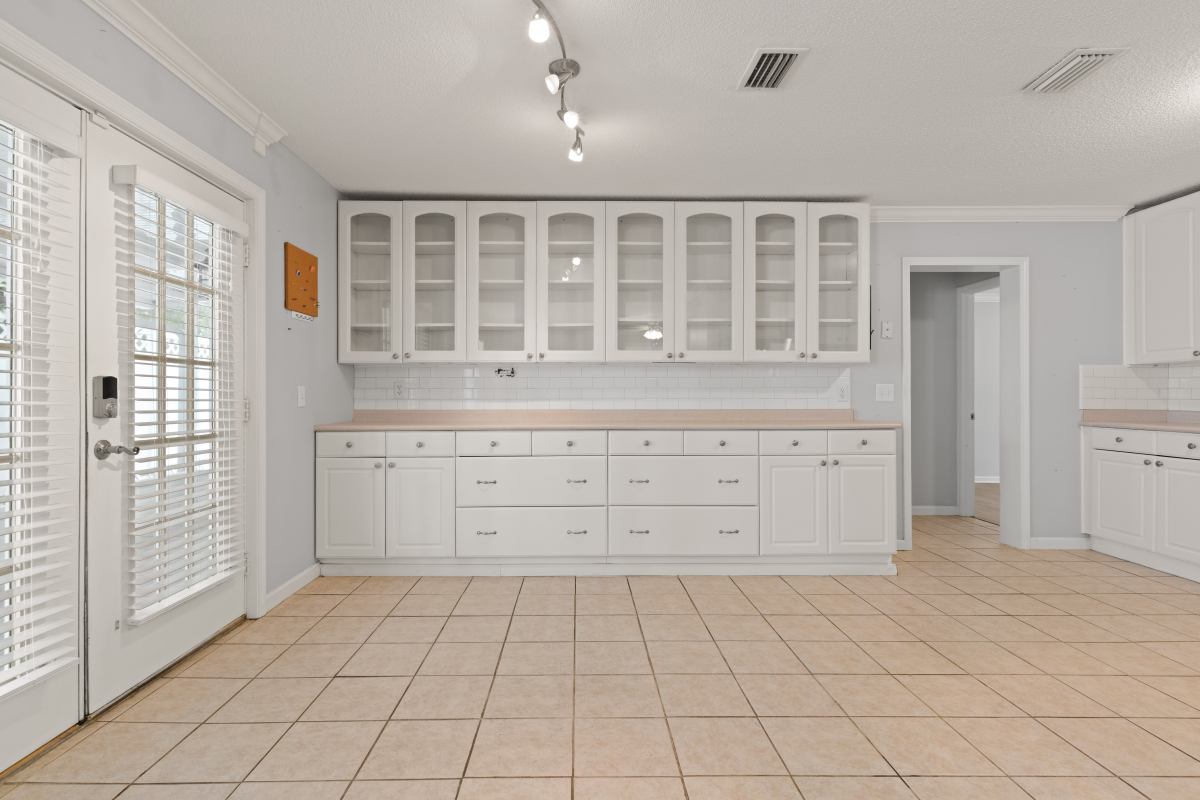 DSC03285 White kitchen with subway tile backsplash and glass cabinet doors in Glynn Haven home