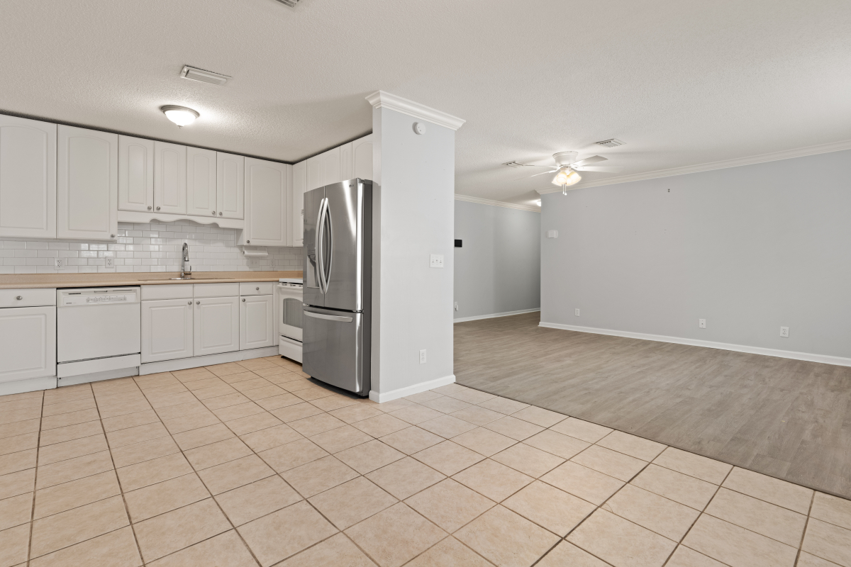 DSC03290 White kitchen with subway tile backsplash and glass cabinet doors in Glynn Haven home