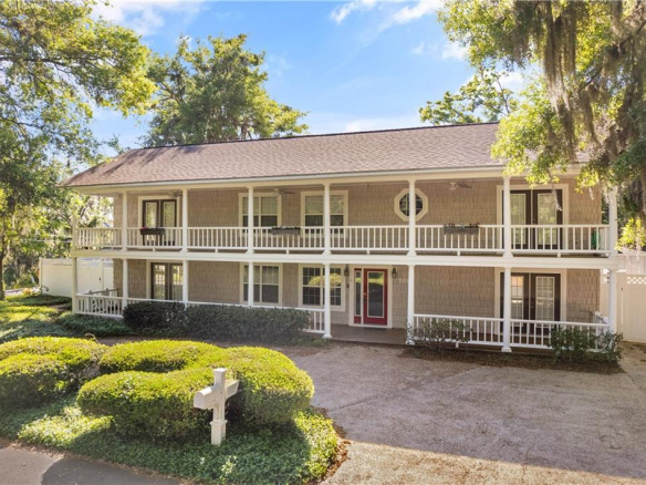 Two-story home for sale in Glynn Haven St Simons Island GA with dual front porches and red entry door