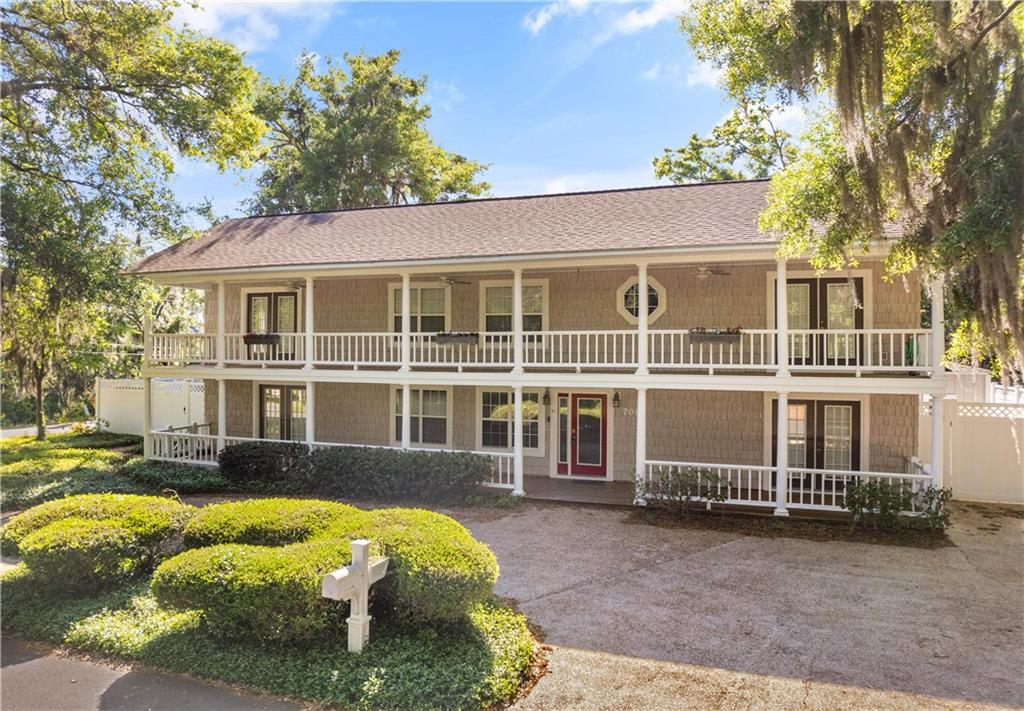 Two-story home for sale in Glynn Haven St Simons Island GA with dual front porches and red entry door